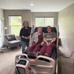 Three caregivers with bed at Trillium House.